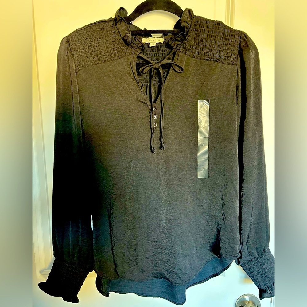 Black sill blouse with accent on neck and sleeves